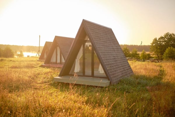 Modern glamping pods in scenic field area